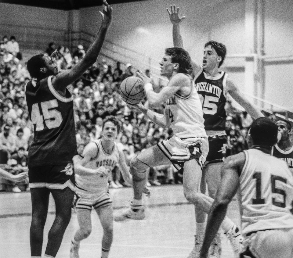 Former SUNY-Potsdam basketball star Steve Babiarz (center), seen protecting the ball against Binghamton defenders, will be inducted into the Greater Utica Sports Hall of Fame in September.