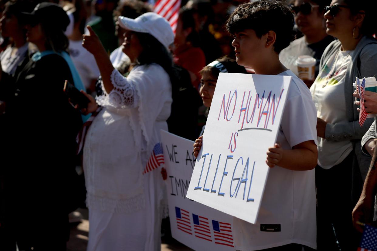 A child holds a sign May 15 during a demonstration in support of the immigrant community before Hispanic Cultural Day at the Capitol in Oklahoma City.