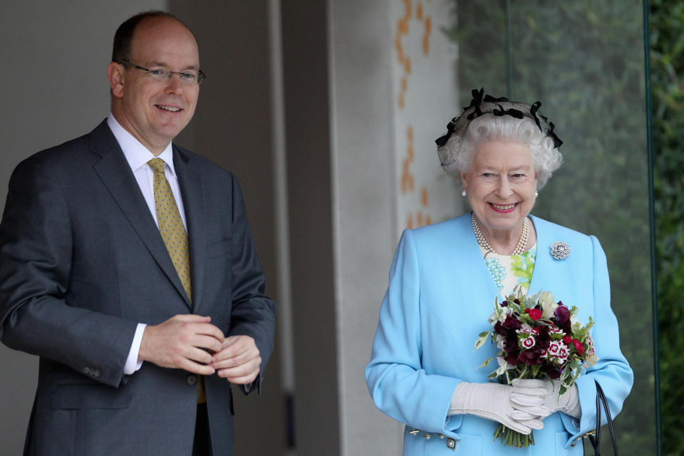 Prince Albert II of Monaco shared an update on his coronavirus diagnosis. Depicted in 2011 with Queen Elizabeth. (Photo: REUTERS/Chris Jackson/Pool)