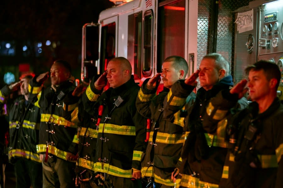 Firefighters salute as the ambulance transporting the body of New York City Police Officer Jonathan Diller exits Jamaica Hospital Medical Center in the Queens borough of New York, Monday, March 25, 2024. Diller was shot and killed Monday during a traffic stop. It marked the first slaying of an NYPD officer in two years. (AP Photo/Jeenah Moon)