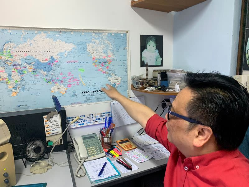 Kelvin Pang, a Singapore-based electronics broker, points to a map in his office in Singapore