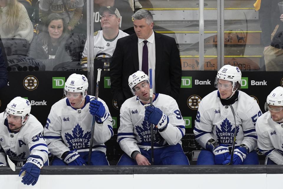 Toronto Maple Leafs coach Sheldon Keefe watches play during the third period in Game 1 of the team's NHL hockey Stanley Cup first-round playoff series against the Boston Bruins, Saturday, April 20, 2024, in Boston. (AP Photo/Michael Dwyer)