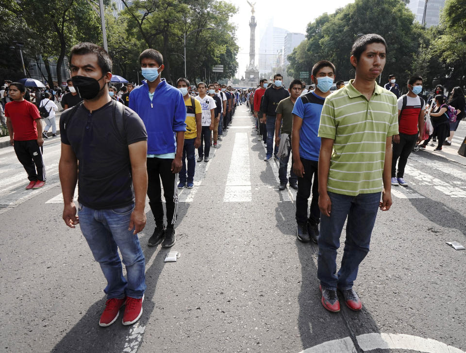 Supporters and relatives of 43 missing university students march on the seventh anniversary of their disappearance, in Mexico City, Sunday, Sept. 26, 2021. Relatives continue to demand justice for the Ayotzinapa students who were allegedly taken from the buses by the local police and handed over to a gang of drug traffickers. (AP Photo/Marco Ugarte)