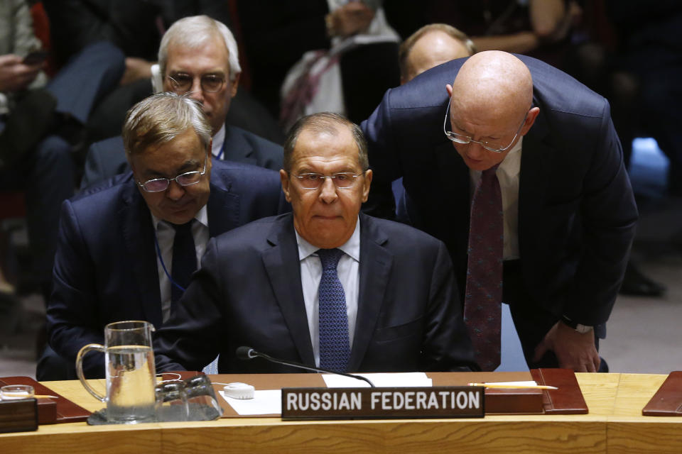 Russian Foreign Minister Sergey Lavrov, center, receives a word from Russian Ambassador to the U.N. Vassily Nebenzia as he attends a meeting of the United Nations Security Council during the 73rd session of the U.N. General Assembly, at U.N. headquarters, Thursday, Sept. 27, 2018. (AP Photo/Jason DeCrow)
