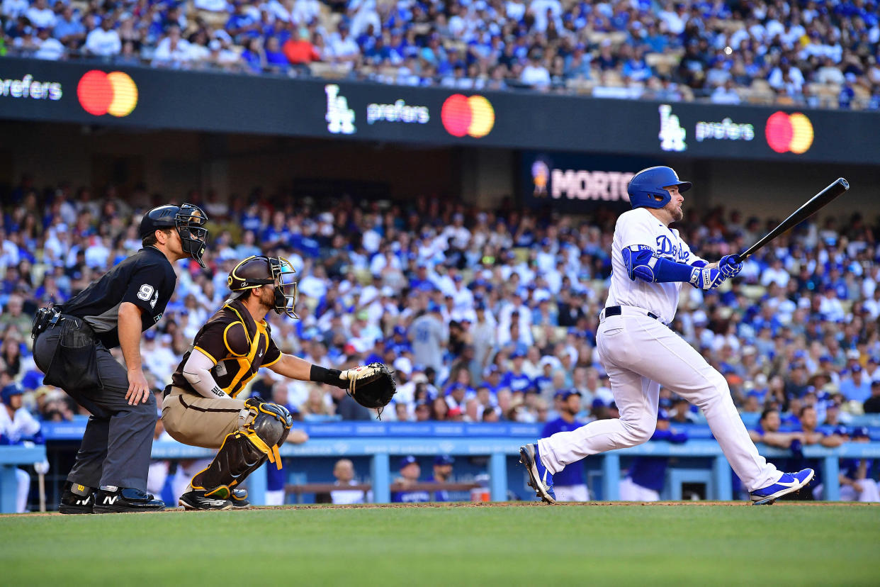 Jul 2, 2022; Los Angeles, California, USA; Los Angeles Dodgers second baseman Max Muncy (13) hits a sacrifice RBI against the San Diego Padres during the seventh inning at Dodger Stadium. Mandatory Credit: Gary A. Vasquez-USA TODAY Sports