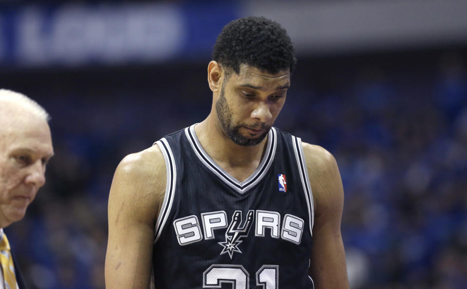 San Antonio Spurs forward Tim Duncan heads to the bench during a timeout in the second half of Game 3 in the first round of the NBA basketball playoffs against the Dallas Mavericks in Dallas, Saturday, April 26, 2014. The Mavericks won 109-108. (AP Photo/LM Otero)