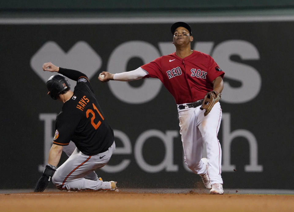 Boston Red Sox third baseman Rafael Devers throws to first after forcing out on Baltimore Orioles' Austin Hays on a ball hit by Adley Rutschman, who was safe during the fourth inning of a baseball game at Fenway Park, Friday, May 27, 2022, in Boston. (AP Photo/Mary Schwalm)