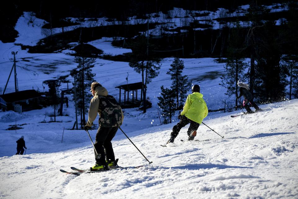 FILE PHOTO: People ski and enjoy the evening sun at an opened ski resort in Saariselka, Inari, Finland June 1, 2020. On Monday Finland lifted much of the restrictions of the COVID-19 pandemic in place, opening libraries, museums, bars, cafes and restaurants. Lehtikuva/Aku Hayrynen via REUTERS  