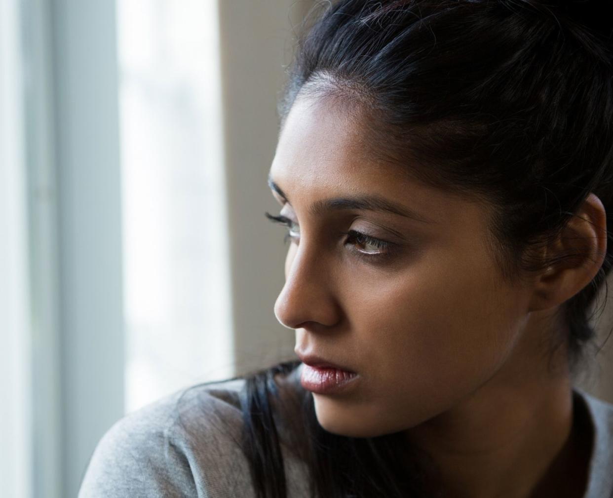 Mother's Day is complicated: contemplative woman looking out window