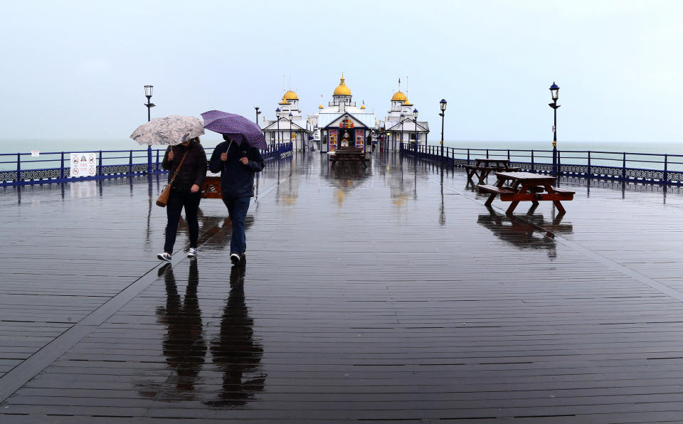 People walk along the pier in Eastbourne, Sussex (Picture: PA)