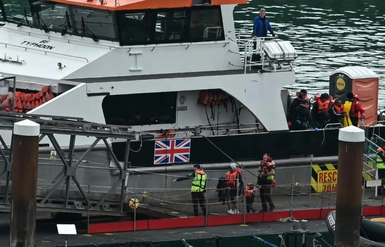 Niños migrantes rescatados en el mar cuando intentaban cruzar el canal de la Mancha desde Francia son ayudados a desembarcar de un barco patrullero británico en el puerto de Dover, el 12 de junio de 2024 al sureste de Inglaterra (Ben Stansall)