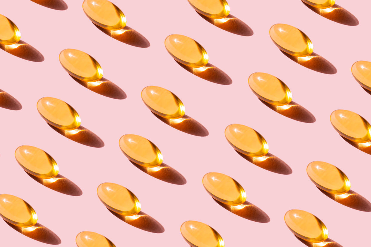 Pop Art Pattern made of Fish oil capsules with Omega 3, vitamin D on pink background Studio shot. The concept of healthy eating, disease prevention and treatment. Taking nutritional supplements and vitamins. Biologically active additives.