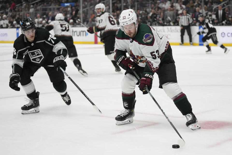 Arizona Coyotes left wing Michael Carcone (53) controls the puck against Los Angeles Kings' Alex Laferriere (78) during the second period of an NHL hockey game Tuesday, Oct. 24, 2023, in Los Angeles. (AP Photo/Ashley Landis)