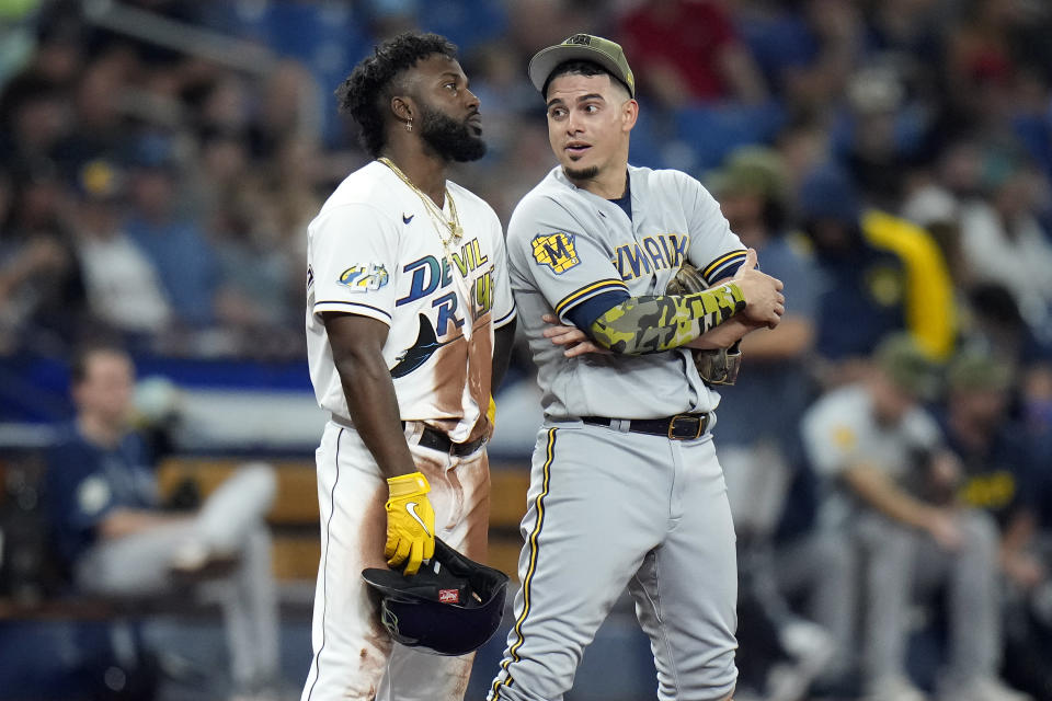 Tampa Bay Rays' Randy Arozarena, left, talks to Milwaukee Brewers shortstop Willy Adames as they watch a challenge on a play at third base during the fourth inning of a baseball game Friday, May 19, 2023, in St. Petersburg, Fla. Adames formally [played for the Rays. (AP Photo/Chris O'Meara)