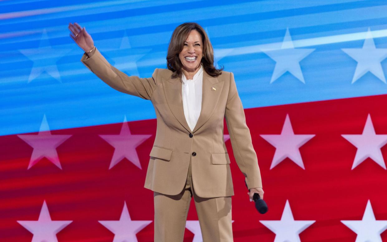 Kamala Harris walks onto the stage during the opening night of the Democratic National Convention