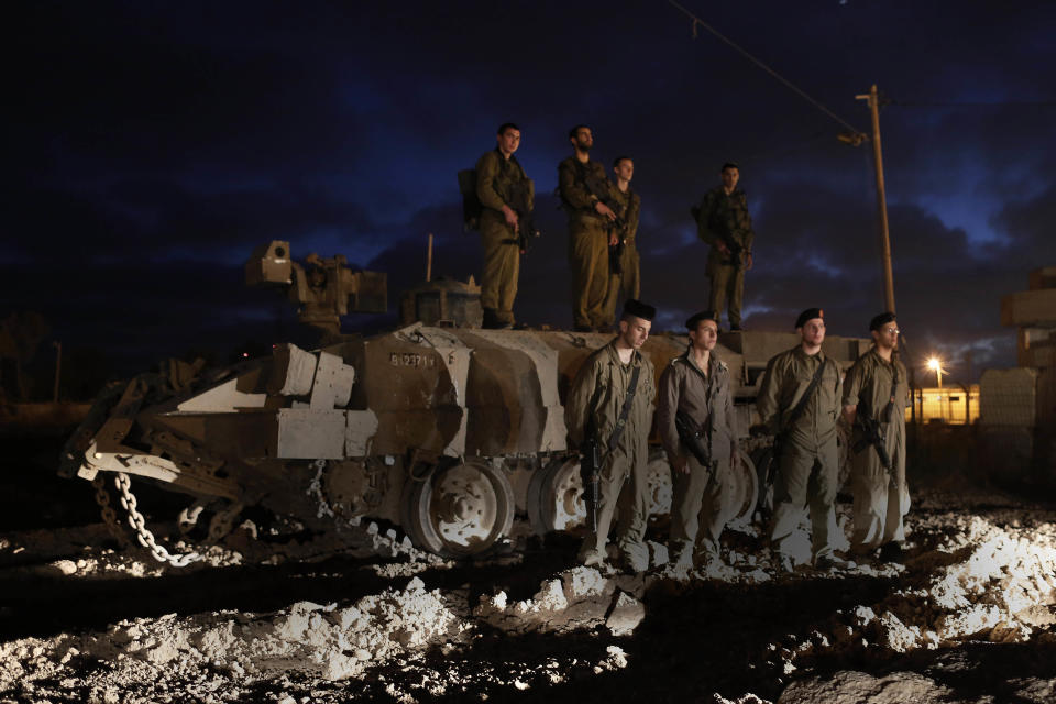 Israeli soldiers stand still as a siren marks the annual Memorial Day for fallen Israeli soldiers, near the Israel border with Gaza Strip,Tuesday, April 24, 2012. (AP Photo / Tsafrir Abayov)