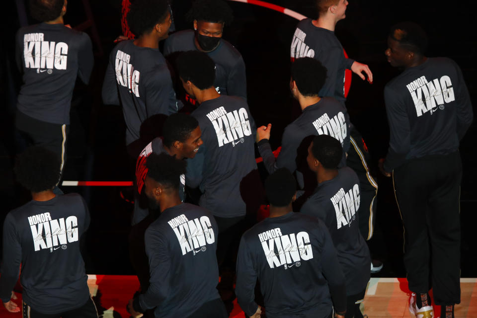 Members of the Atlanta Hawks wear shirts commemorating MLK Day prior to an NBA basketball game against the Minnesota Timberwolves on Monday, Jan. 18, 2021, in Atlanta. (AP Photo/Todd Kirkland)