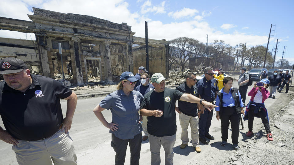 FILE - Hawaii Gov. Josh Green, center, points to damage as he speaks with Federal Emergency Management Agency Administrator Deanne Criswell during a tour of wildfire damage, Saturday, Aug. 12, 2023, in Lahaina, Hawaii. An acute housing shortage hitting fire survivors on the Hawaiian island of Maui is squeezing out residents even as they try to overcome the loss of loved ones, their homes and their community. (AP Photo/Rick Bowmer, File)