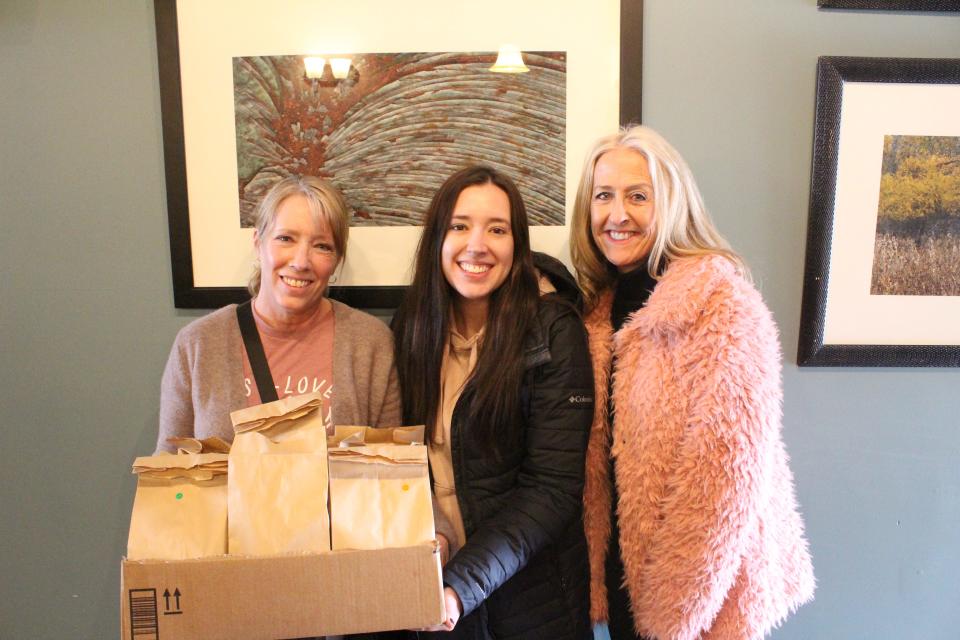 Locals drop off brown bag lunches to support homeless and shut-ins at Two Brothers Coffee Brew and Eatery on Friday, March 4. Pictured from left are Kimberly Goodwin, Rebecca Chromey and Diane Soulliere.