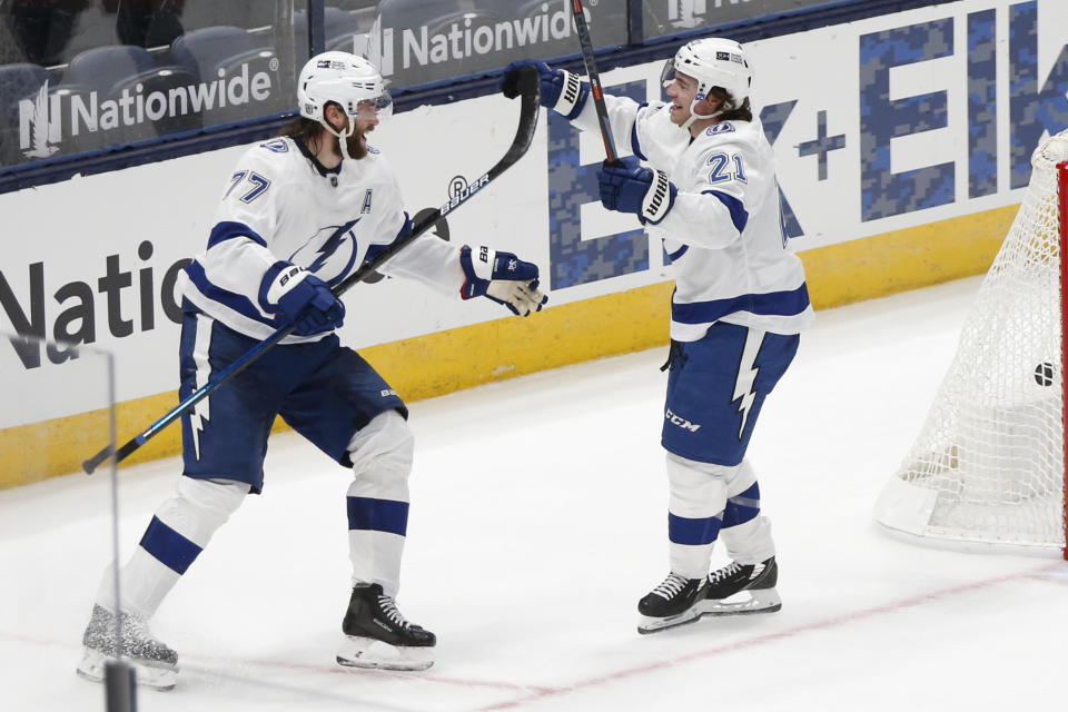 Tampa Bay Lightning's Brayden Point, right, celebrates his goal against the Columbus Blue Jackets with Victor Hedman in overtime of an NHL hockey game Thursday, Jan. 21, 2021, in Columbus, Ohio. (AP Photo/Jay LaPrete)