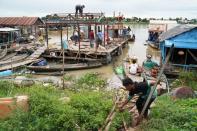 Residents demolish their floating houses on the Tonle Sap river after they were ordered to leave within one week of being notified by local authorities in Prek Pnov district
