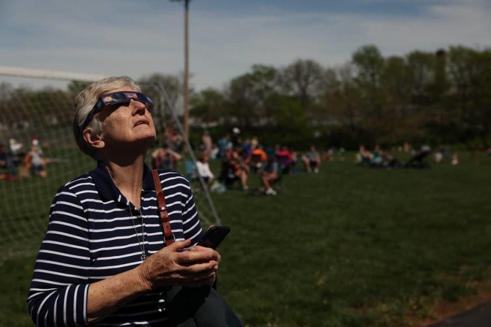 Betsy Rogers, 78, of Belleville, stares up to the sky as the moon crosses completely in front of the sun during the total solar eclipse in Red Bud, Ill., on April 8, 2024. “This is a once in a lifetime opportunity,” Rogers said.