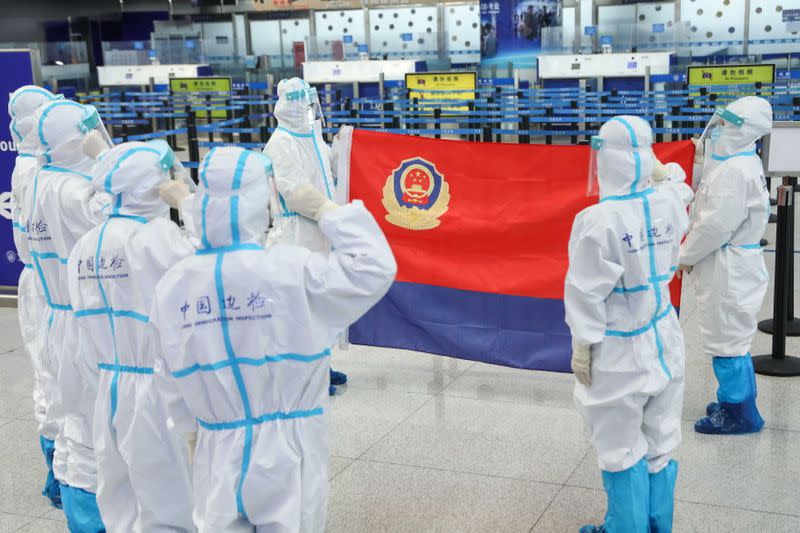 Police officers revisit their oath ahead of China's first People's Police Day, at the airport in Qingdao