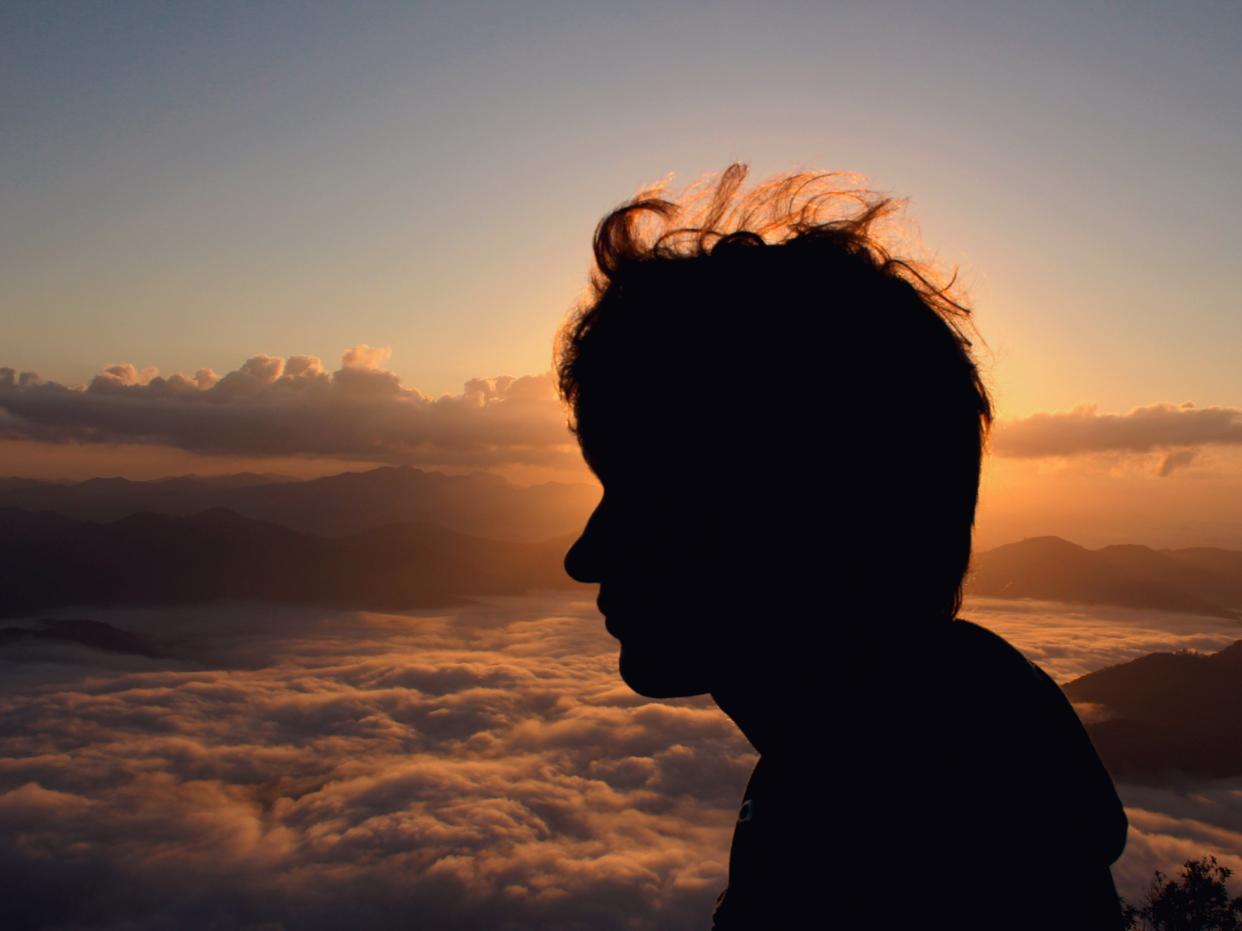 silhouette man clouds alone thinking hopeful