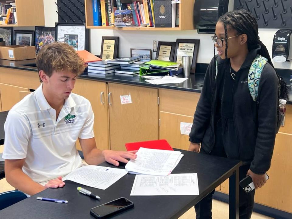 “World Religions and the Bible in History” students Camden Dinkenor and Dayna Wilkerson analyze content to synthesize new findings during independent learning activities.
