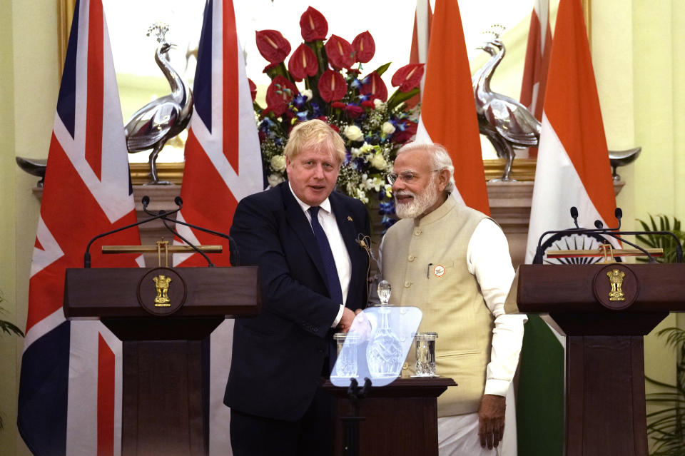 Indian Prime Minister Narendra Modi shakes hand with his British counterpart Boris Johnson after signing of memorandums and making press statements, in New Delhi, Friday, April 22, 2022. India and Britain on Friday called on Russia for an immediate ceasefire in Ukraine as British Prime Minister Boris Johnson announced steps to help move New Delhi away from its dependence on Russia by expanding economic and defense ties. (AP Photo/Manish Swarup)