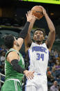 Orlando Magic's Wendell Carter Jr. (34) takes a shot over Boston Celtics' Enes Kanter, left, during the first half of an NBA preseason basketball game, Wednesday, Oct. 13, 2021, in Orlando, Fla. (AP Photo/John Raoux)