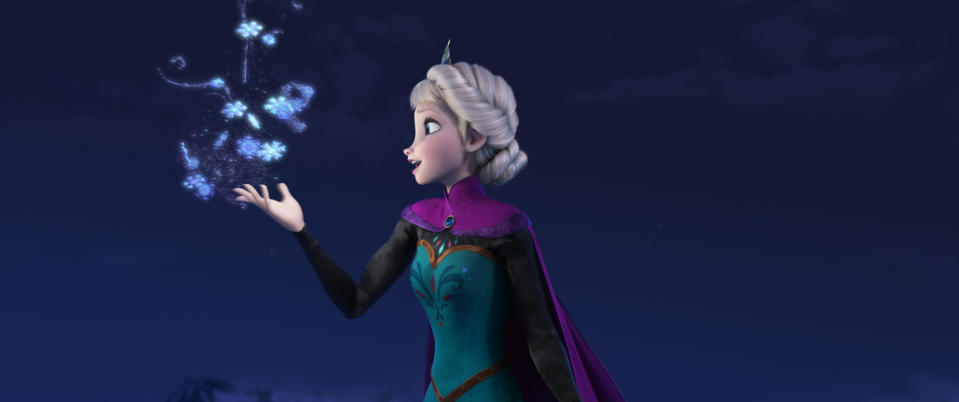 Elsa from Frozen creating snowflakes with her magical powers in the night sky. She is wearing her iconic dress and cape