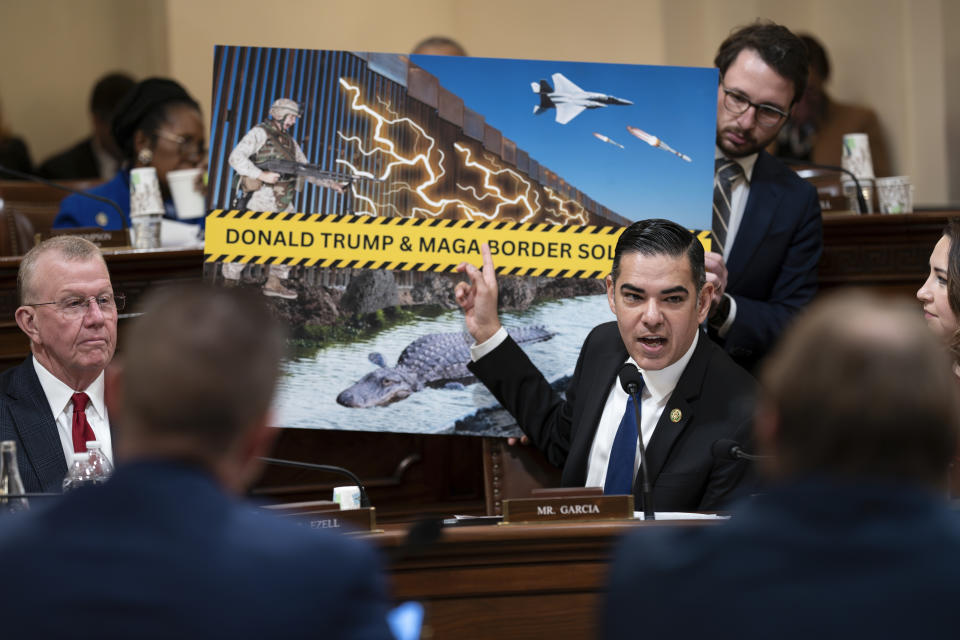 Rep. Robert Garcia, D-Calif., uses a graphic as Republicans on the House Homeland Security Committee move to impeach Secretary of Homeland Security Alejandro Mayorkas over the crisis at the U.S.-Mexico border, at the Capitol in Washington, Tuesday, Jan. 30, 2024. Democrats call the proceedings a sham ordered up by Donald Trump, the GOP presidential front-runner, who opposes an emerging bipartisan border security package in the Senate. (AP Photo/J. Scott Applewhite)