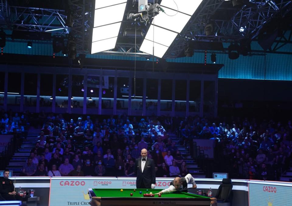 Barry Hawkins compiles a break as Mark Selby, extreme left, looks on (Adam Davy/PA) (PA Wire)