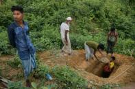 Rohingya refugees prepare a grave for a neighbour who died at the Kutupalong refugee camp