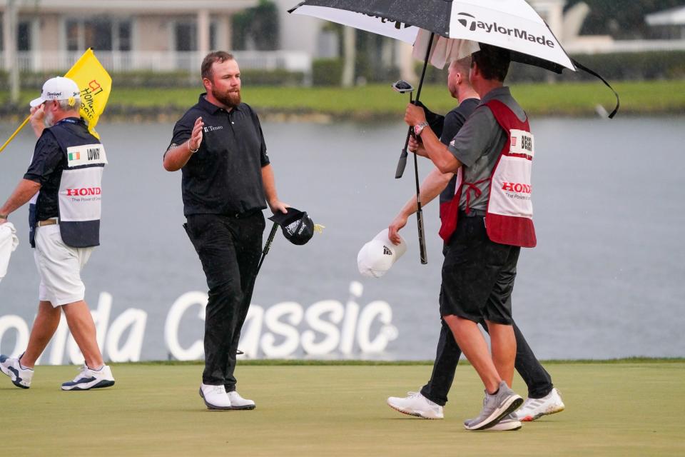 Shane Lowry, left, and Daniel Berger, who battled Sunday for the Honda Classic lead, congratulate each other on the 18th hole after finishing the final round.