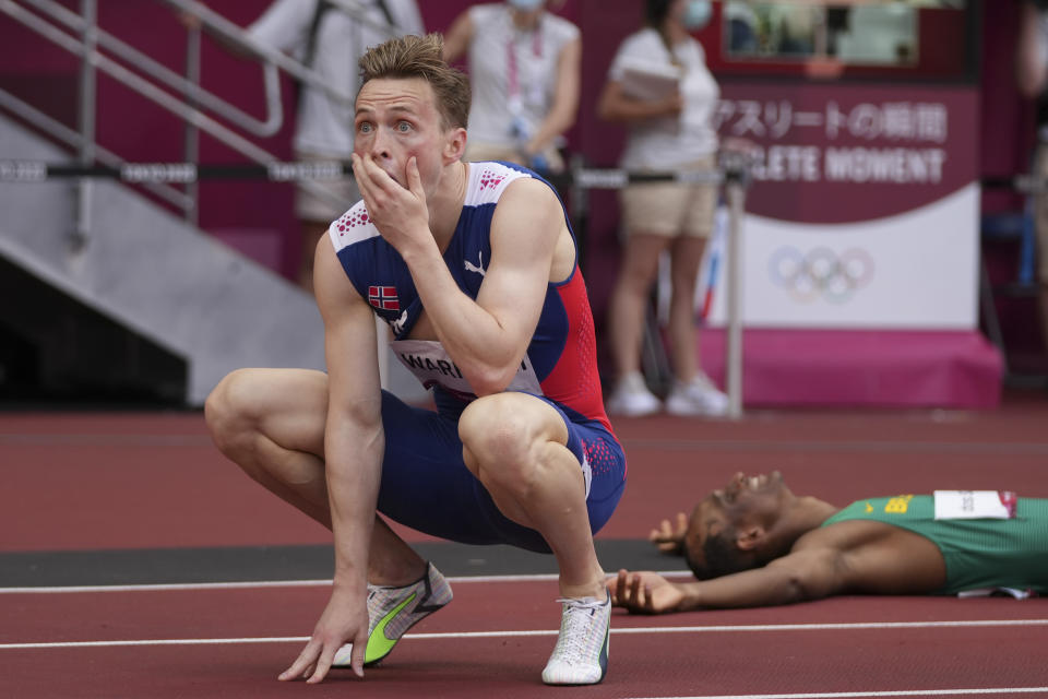 Karsten Warholm, of Norway, celebrates after winning the gold medal in the men's 400-meter hurdles at the 2020 Summer Olympics, Tuesday, Aug. 3, 2021, in Tokyo. (AP Photo/Matthias Schrader)