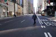 FILE PHOTO: A lone man crosses 5th Ave following the outbreak of coronavirus disease (COVID-19), in the Manhattan borough of New York City