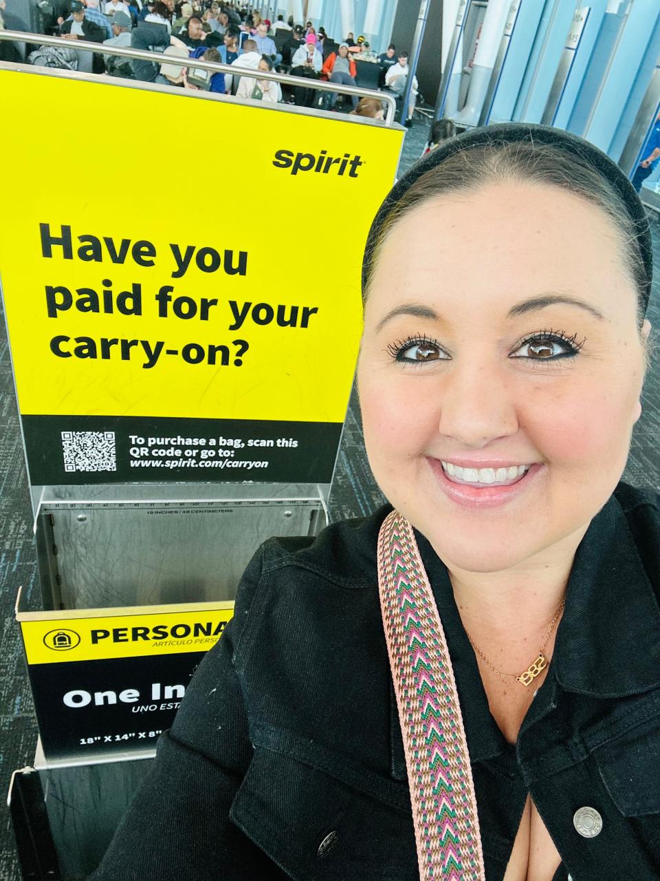 Author Carly Caramanna smiling at Spirit airlines terminal 