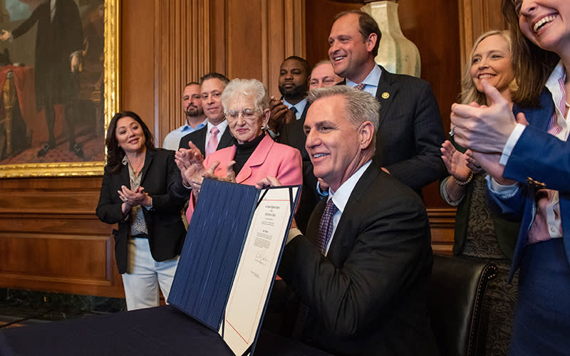 House Speaker Kevin McCarthy (R-Calif.) poses for a photo during a bill enrollment ceremony