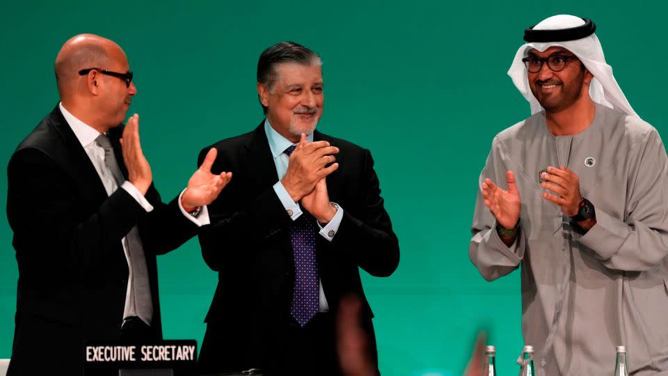 COP28 President Sultan Al Jaber, from right, celebrates the new climate agreement with summit CEO Adnan Amin and UN Climate Change Executive Secretary Simon Stiell in Dubai.  - Kamran Jebreili/AP