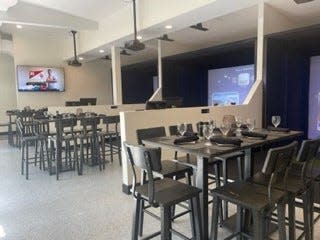 At 19th Hole Virtual Golf Bar and Grill in Vero Beach, the decor is crisp, clean, uncluttered and modern with grayscale tones.