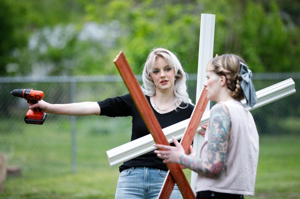 Heidi Mae Herrington (left), 34, and AJ Jenkins, 30, discuss the setup of their recreation of the movie poster for the slasher-horror film "Pearl" on Thursday, May 4, 2023.