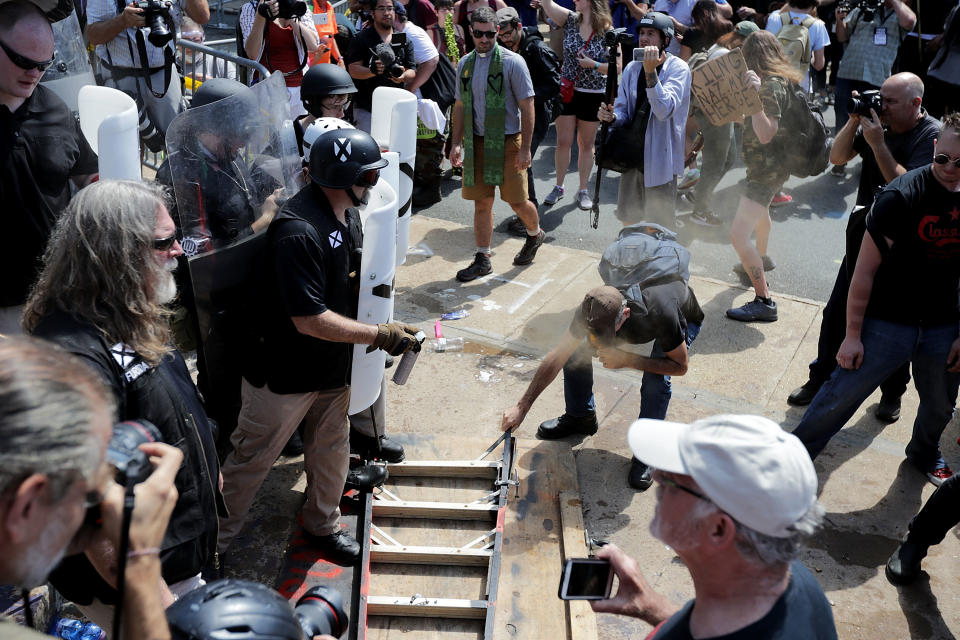 <p>White nationalists, neo-Nazis and members of the “alt-right” clash with counter-protesters as they attempt to guard the entrance to Lee Park during the “Unite the Right” rally Aug. 12, 2017 in Charlottesville, Va. (Photo: Chip Somodevilla/Getty Images) </p>