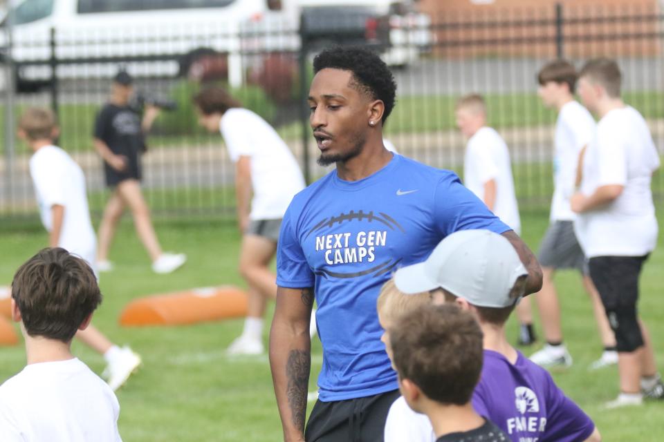 Former Madison Ram and current Kentucky Wildcat Tyrell Ajian instructs a group of campers during the Nike Skills Football Camp at Arlin Field this week.