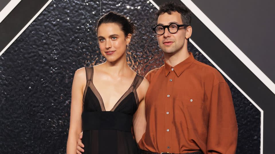 Margaret Qualley, posing with husband Jack Antonoff, wore a feathery black chiffon Chanel dress modeled on a look from the label’s Haute Couture Fall-Winter 1995/96 collection. - Andrew Kelly/Reuters