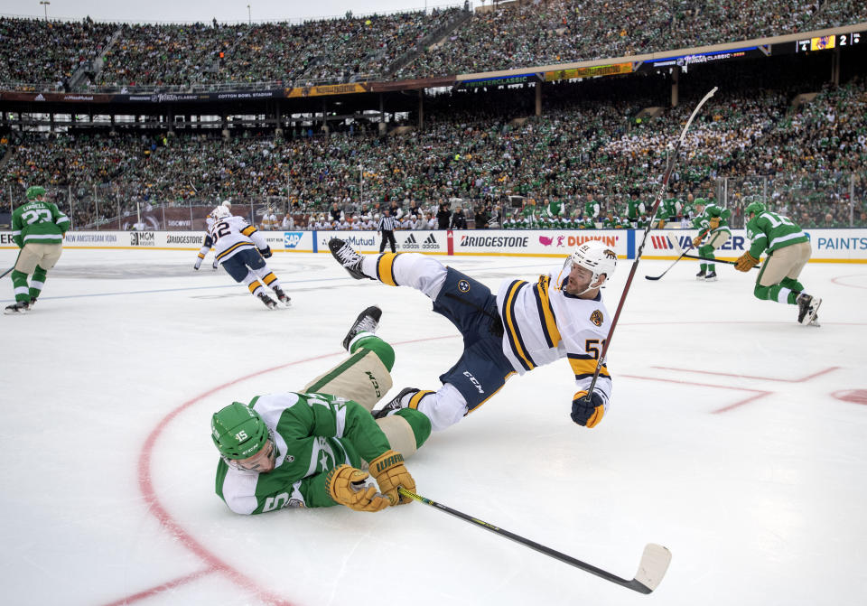 Dallas Stars left wing Blake Comeau (15) falls to the ice after being checked by Nashville Predators left wing Austin Watson (51) in the first period of the NHL Winter Classic hockey game at the Cotton Bowl, Wednesday, Jan. 1, 2020, in Dallas. (AP Photo/Jeffrey McWhorter)