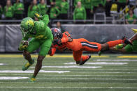 Oregon wide receiver Devon Williams (2) gets away from Oregon State defensive back Alex Austin (5) after a catch in the second quarter of an NCAA college football game Saturday, Nov. 27, 2021, in Eugene, Ore. (AP Photo/Andy Nelson)