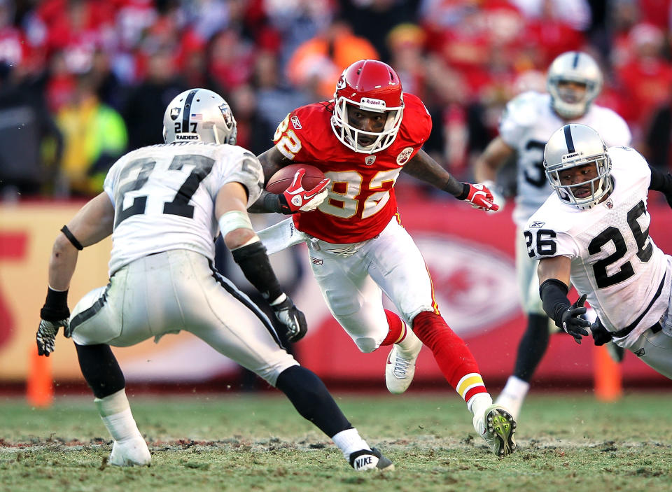 Receiver Dwayne Bowe #82 of Kansas City Chiefs carries the ball after making a catch as Matt Giordano #27 of the Oakland Raiders defends during the game on December 24, 2011 at Arrowhead Stadium in Kansas City, Missouri. (Photo by Jamie Squire/Getty Images)