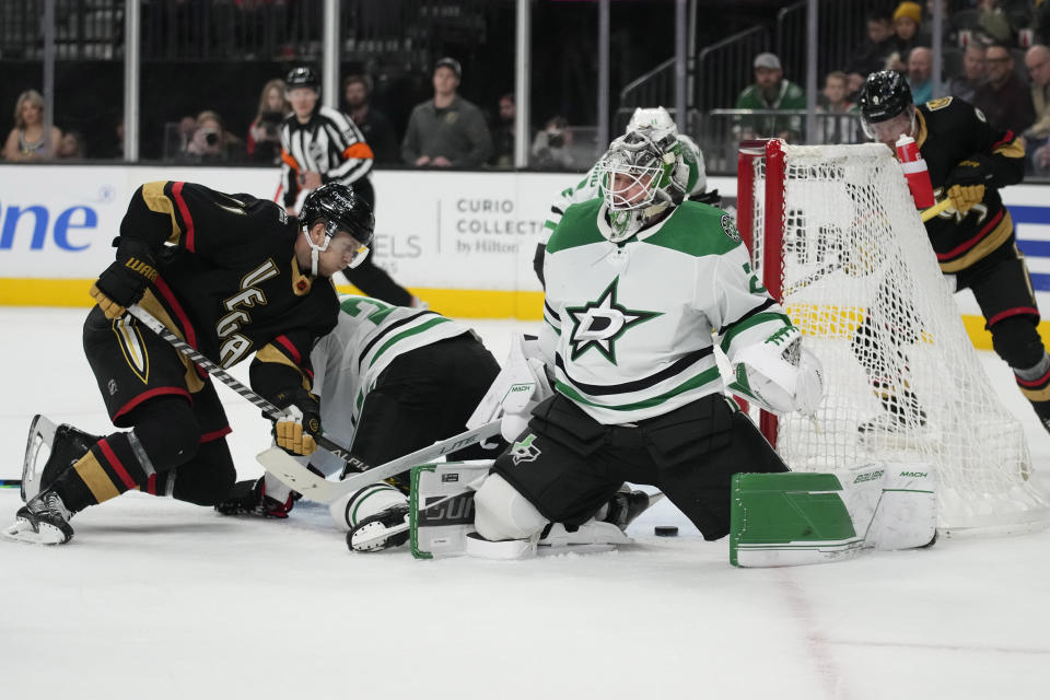 Vegas Golden Knights center William Karlsson (71) attempts to get the puck past Dallas Stars goaltender Jake Oettinger (29) during the second period of an NHL hockey game Monday, Jan. 16, 2023, in Las Vegas. (AP Photo/John Locher)